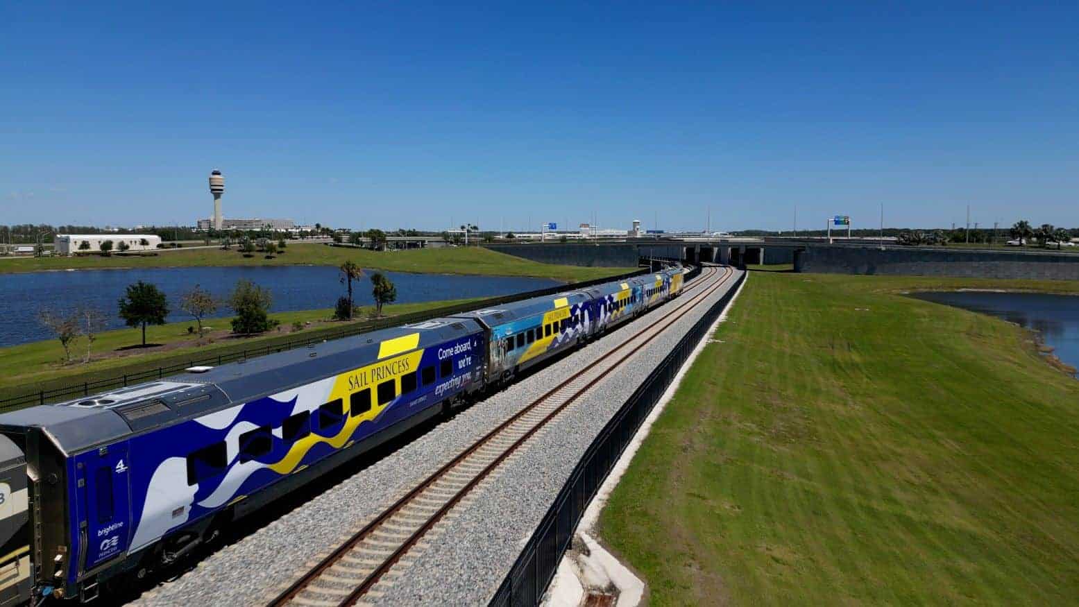 Brightline train wrapped in princess cruise lines branding.