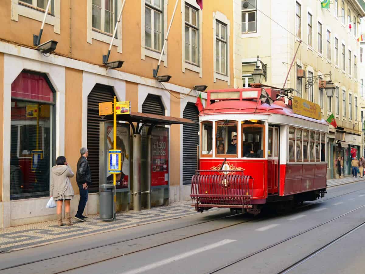 Cable car at a stop sign along Rua Augusta shopping area.