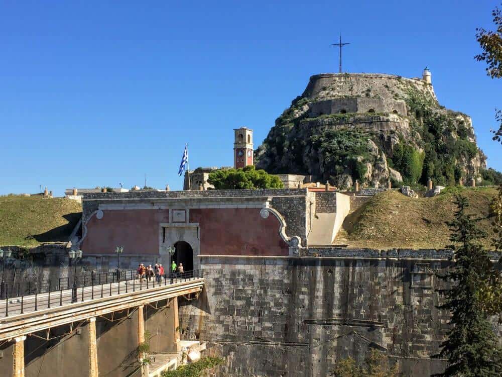 Cruise passengers walk across the bridge to the old fortress