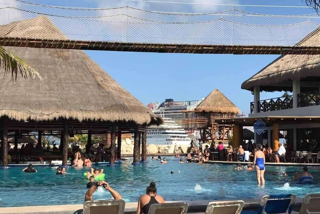 Busy and crowded swimming pool at entertainment complex in the port.