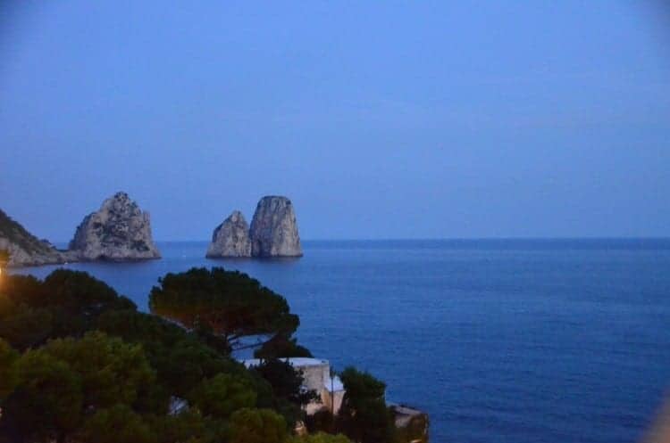 The Faraglioni rock formations off the coast of romantic Capri tower more than 300-feet above the sea, on a Mediterranean cruise.