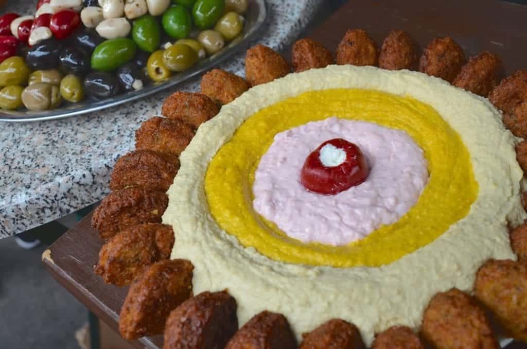 Platter of tri-colored hummus and falafel.