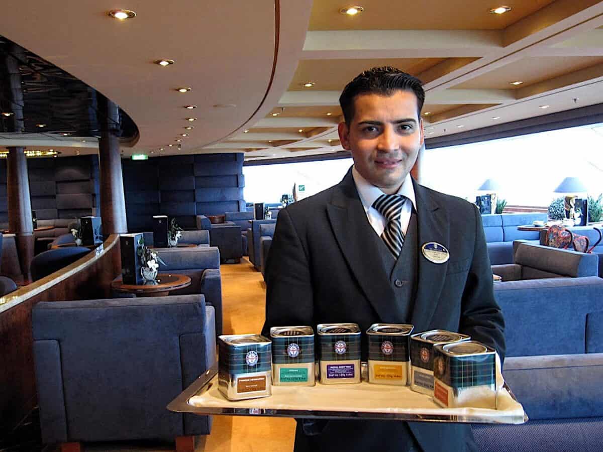 MSC Splendida butler serving tea in Topsail Lounge.