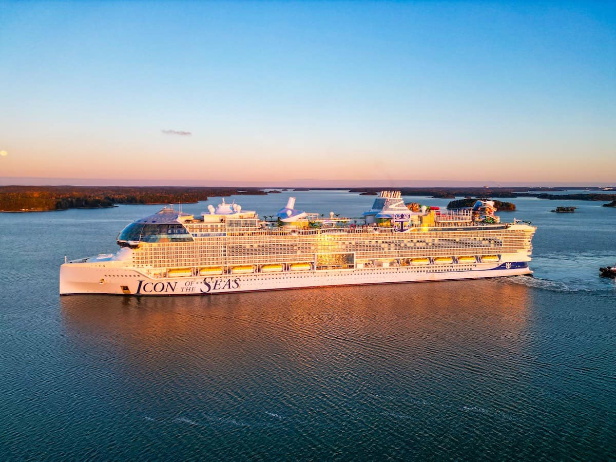 Royal Caribbean Icon of the Seas at sea during sunset.