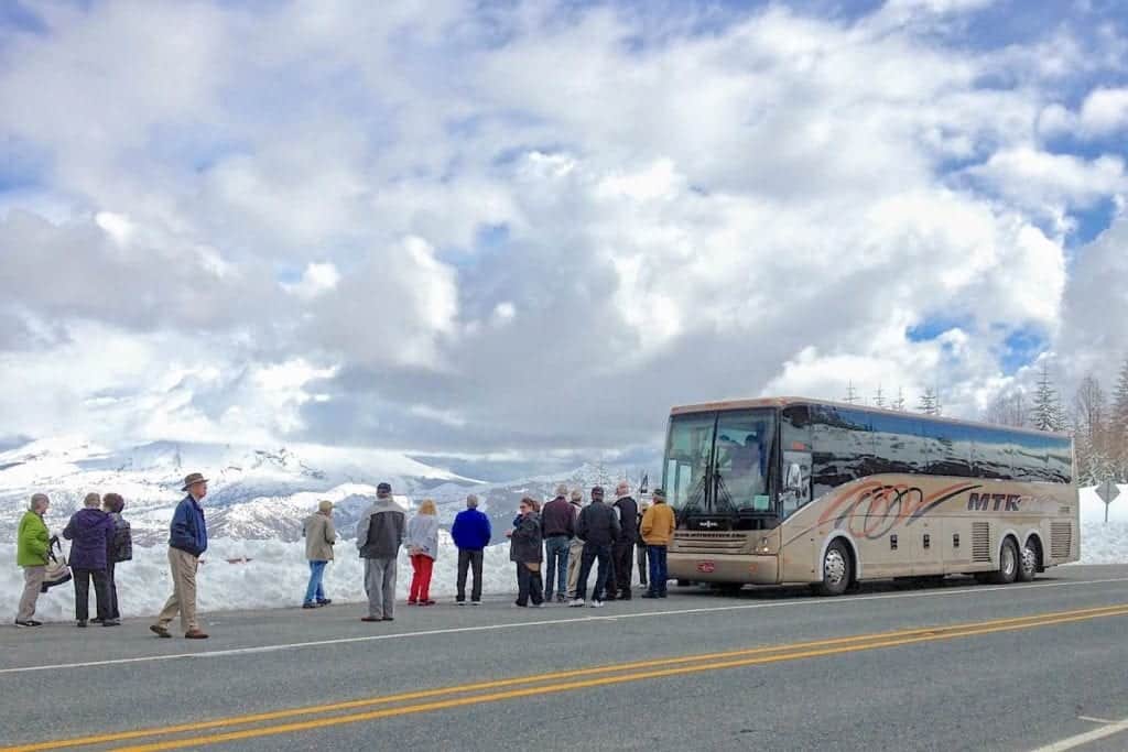 Queen of the West passengers off the bus to look at Mount St. Helens