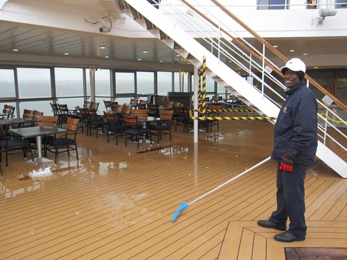 Crew member shoveling snow on the pool deck.