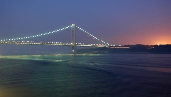 Cunard Queen Mary 2 nearing Verrazano Bridge in NYC at dawn.