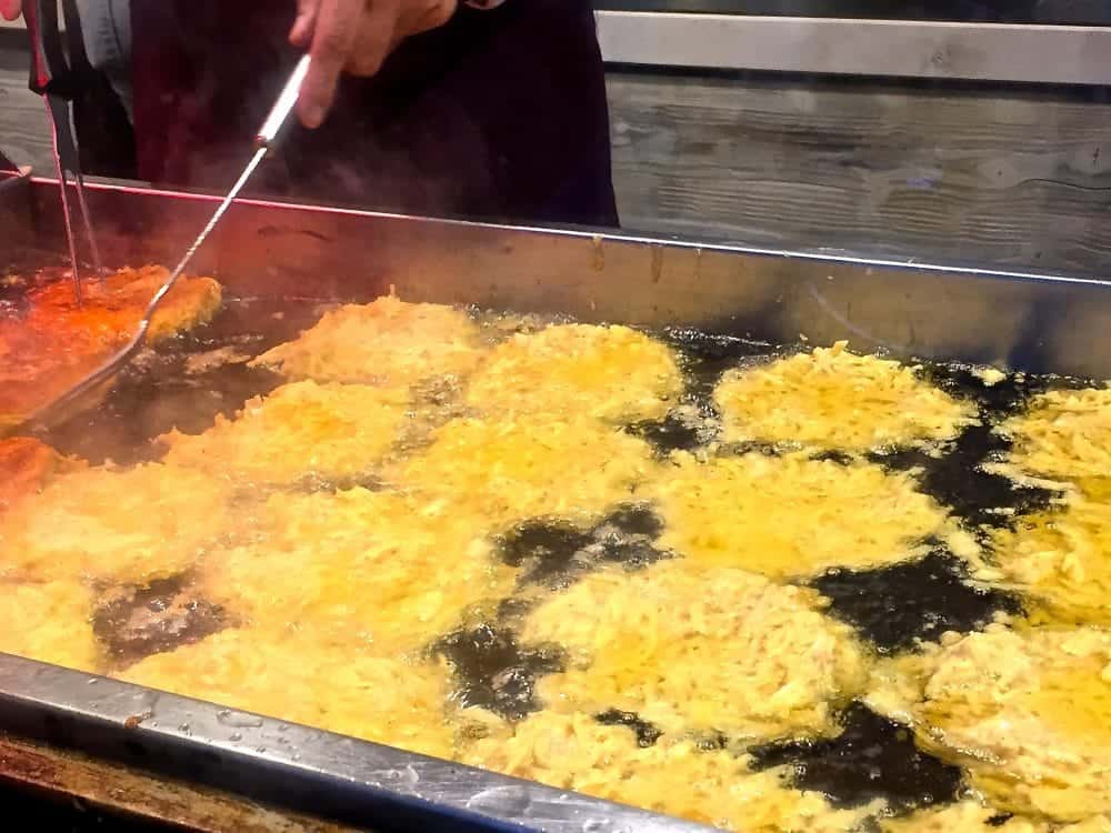 Frying those oh so dee-licious potato pancakes.