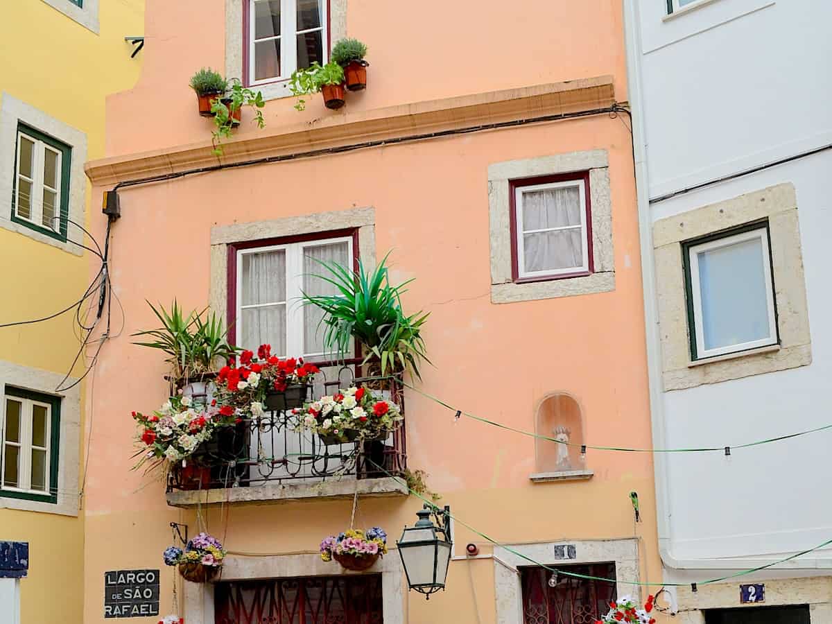 Beautiful flowers and a shrine decorate the front of this apartment home.