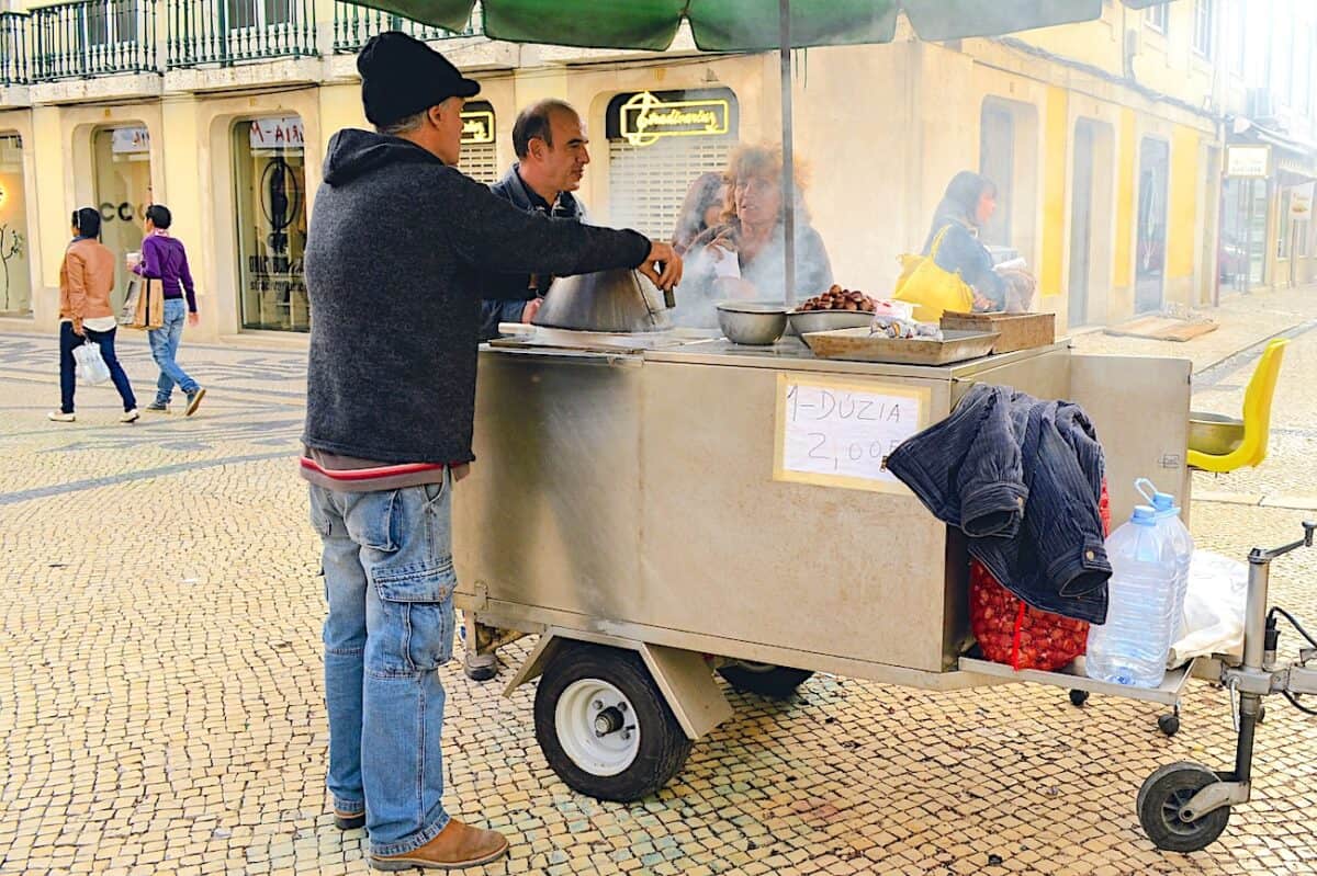 Street vendor in Lisbon selling roasted chestnuts.