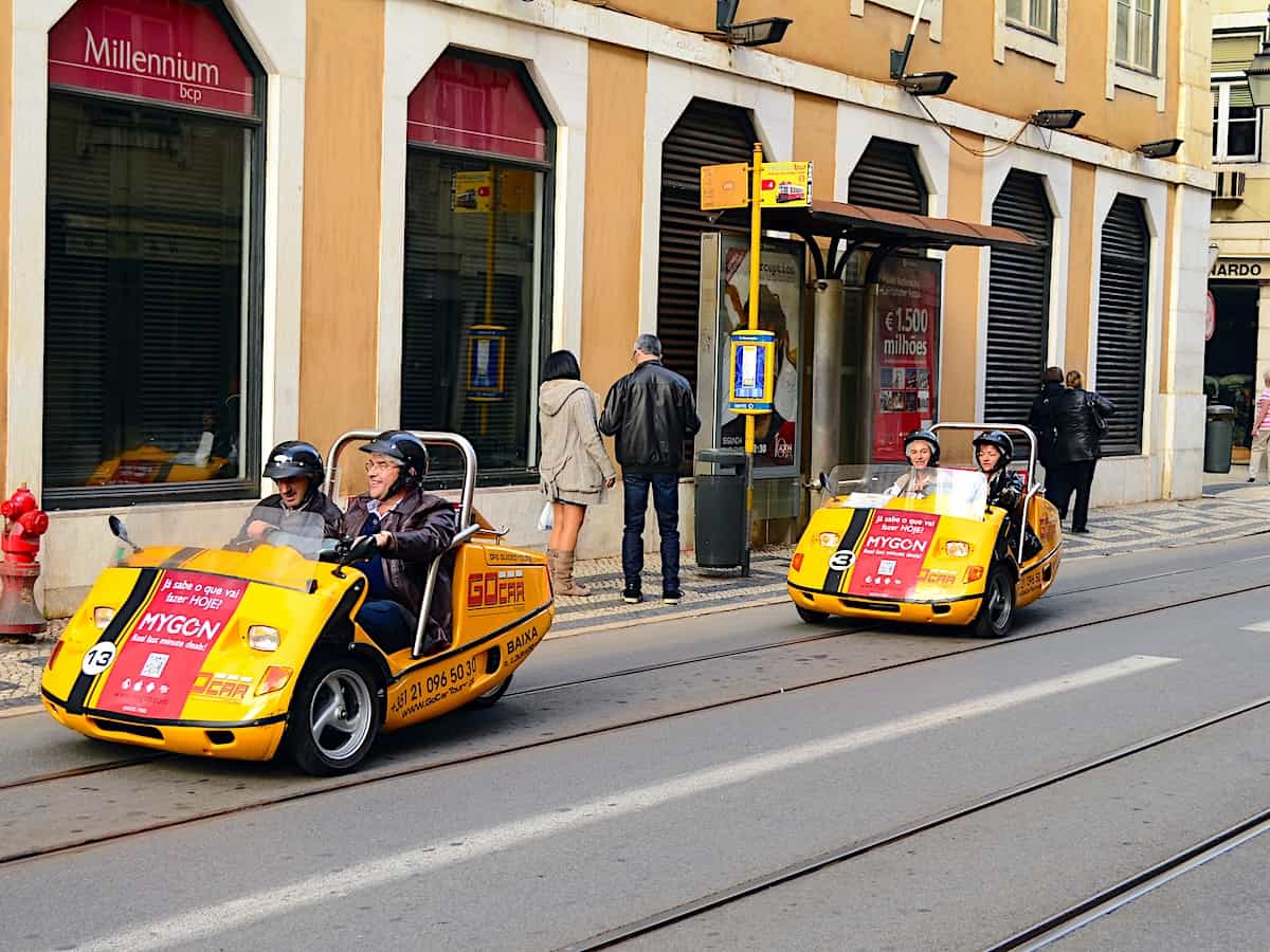 Tiny two-seater rental cars for tourists in downtown Lisbon.