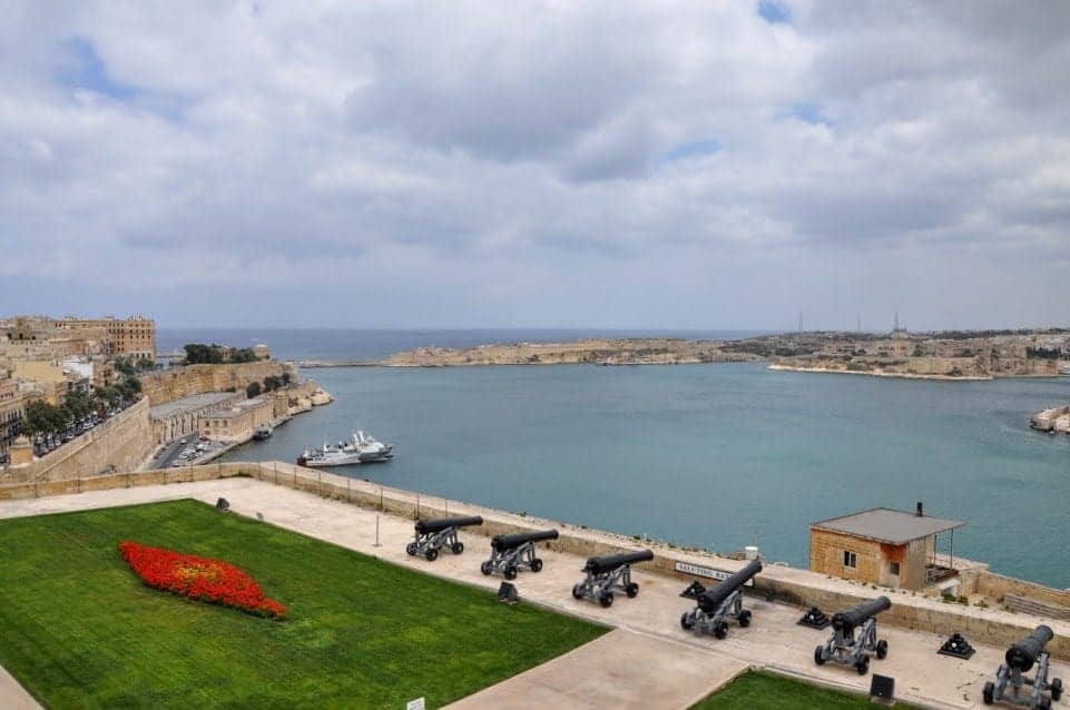 View from Upper Barrakka Gardens with a row of cannons pointing to the harbor.