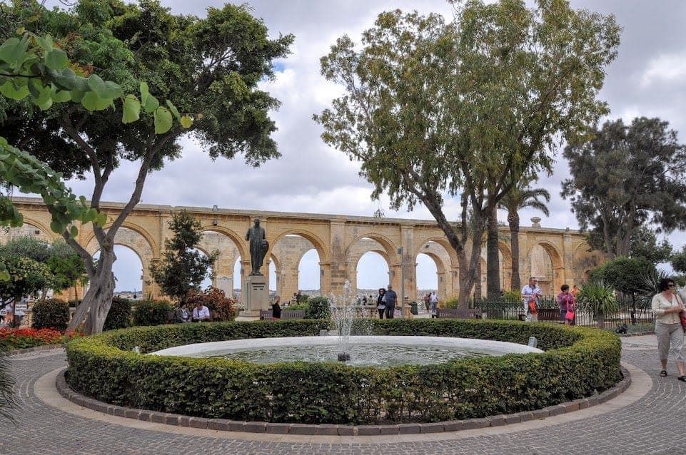 Fountain surrounded by shrubs at the Upper Barrakka Gardens in Valletta Malta.