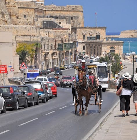 Valletta Malta horse and buggy with tourists riding through the Old Town