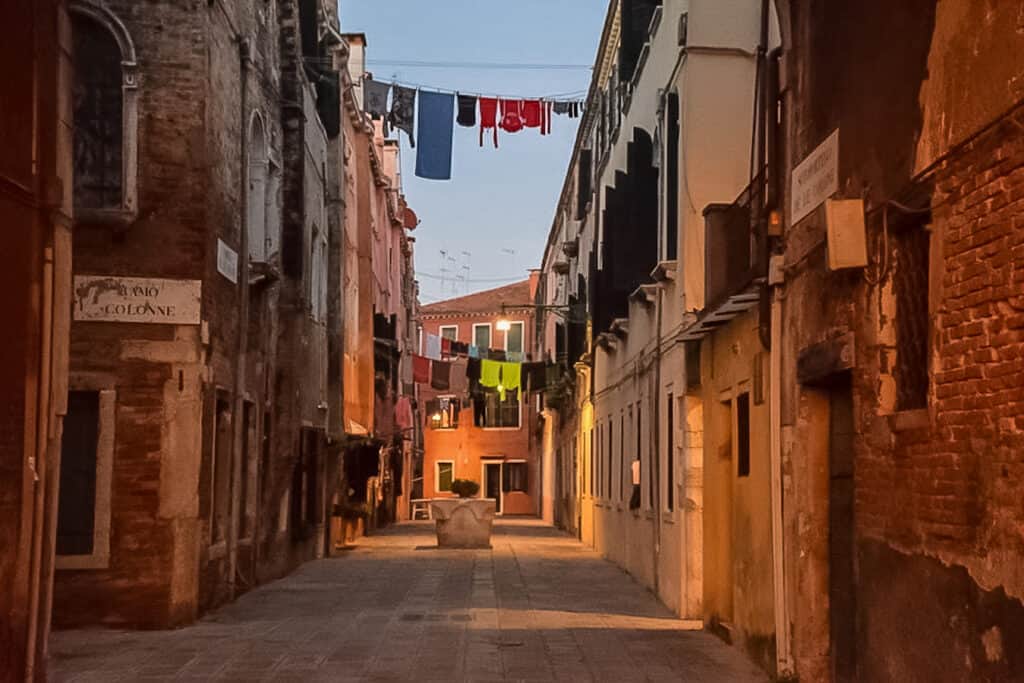 Venice alley at night with clothes on the line.