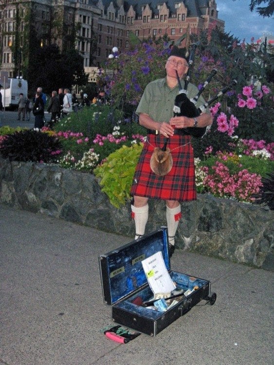 A bagpiper in the Inner Harbor fills the night air with lively tunes in Victoria, B.C.