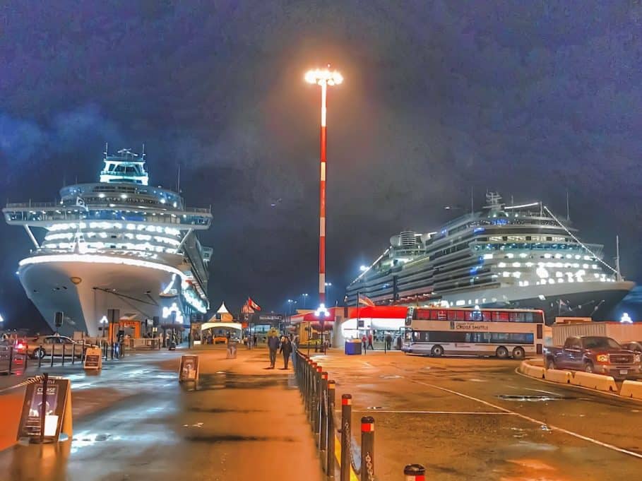 Two cruise ships docked at night in Victoria Canada for required port call.