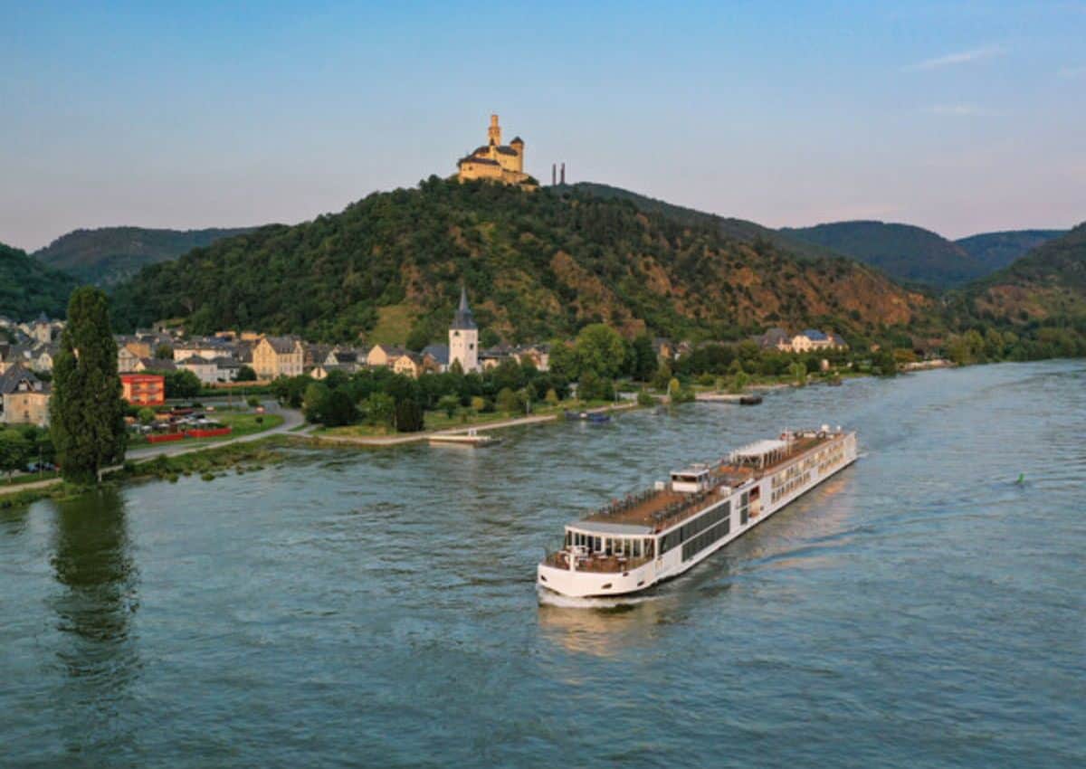 Viking River Cruise Long Ship Sailing Down A European River.